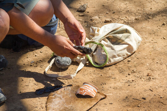 Two male hands hold vestiges of an ancient civilization in the archaeological park of Guachimontones in Jalisco, Mexico