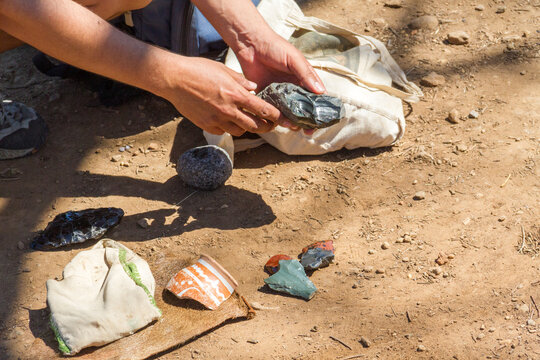 Two male hands hold vestiges of an ancient civilization in the archaeological park of Guachimontones in Jalisco, Mexico