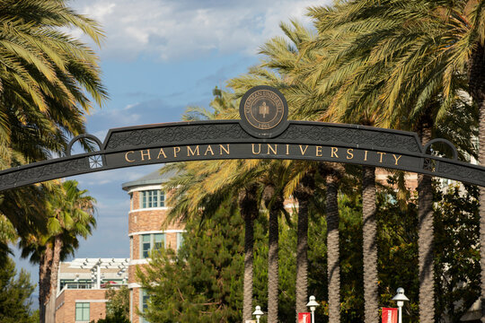 Orange, California, USA - June 23, 2021: Sun shines on a sign at the entrance of Chapman University.