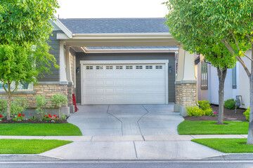 Garage of a house with concrete driveway intersecting with the sidewalk at Daybreak, Utah - obrazy, fototapety, plakaty