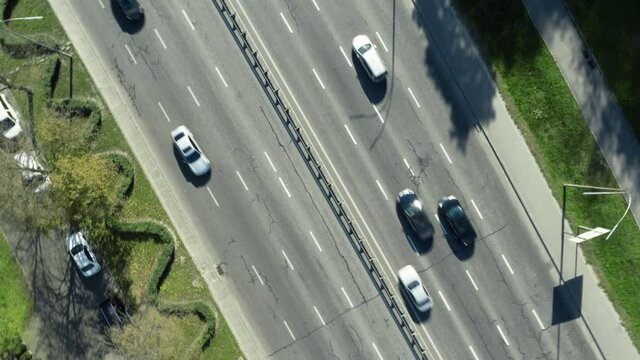 Fast turning shot above of road with moving cars.