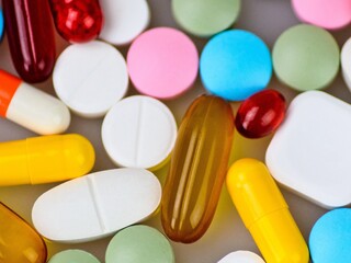 Various Colorful Pills on Gray Background