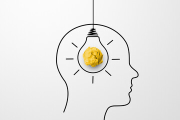 Concept creative idea and innovation. Paper scrap ball yellow colour and light bulb in head human...