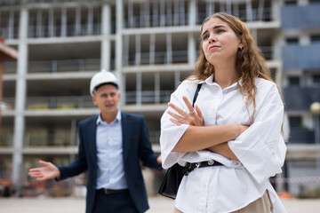 Depressed woman engineer or architect having problems in work at construction site
