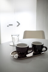 selective focus on two small black coffee cups on the table