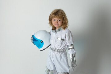 Boy playing to be an astronaut with space helmet and metal suit. Little boy astronaut. © Volodymyr