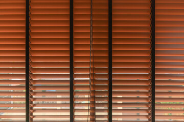 Venetian blind window, Office window blinds in red tone to block control screening sunlight through in the room interior decoration for modern building or home and living.