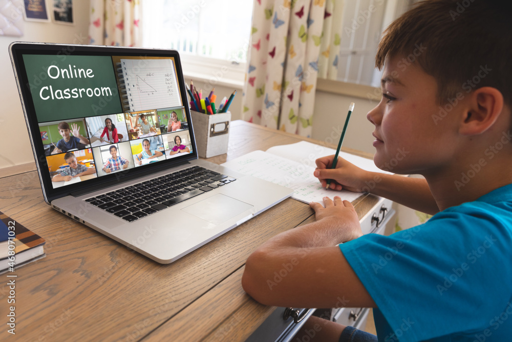 Poster Caucasian boy using laptop for video call, with smiling diverse elementary school pupils on screen