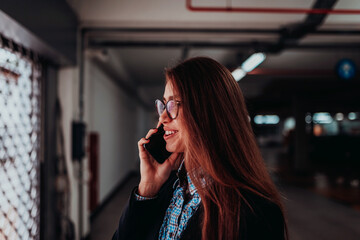 An attractive business woman in glasses using a smartphone. Selective Focus. Business Portrait