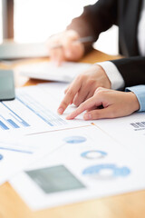 businesswoman analyzing business strategy using graph and chart.