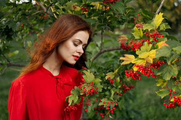 Naklejka premium cheerful woman eating berries outdoors fresh air