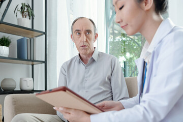 Fototapeta premium Senior man listening to doctor enumerating list of prescribed medicine