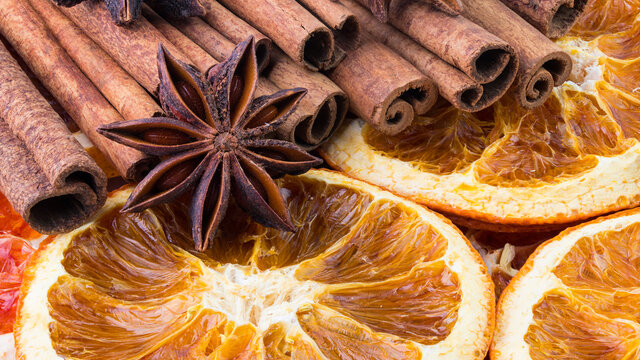 Cinnamon sticks, Dried citrus orange slices and Anise stars, background. Aromatic spices for Drink, cooking or baking. Macro High resolution photo. Professional food photography. Full depth of field. 