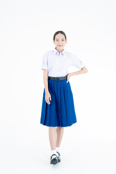 Young woman wearing high school uniforms. Girl wears a school uniform in an isolated background. Thai Student.