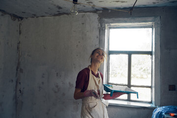 woman paints house decoration interior renovation painter