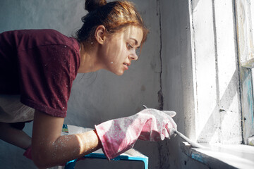 woman painter paint window home interior renovation