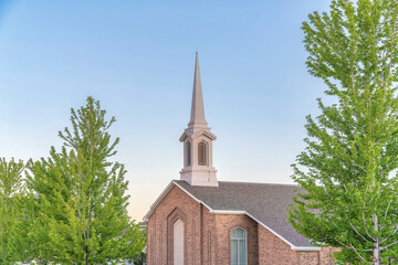 Top exterior of a church in Utah with trees outdoors
