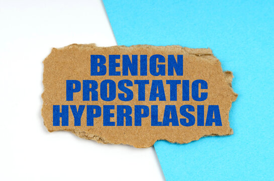 On a blue and white background lies a piece of cardboard with the inscription - Benign Prostatic Hyperplasia