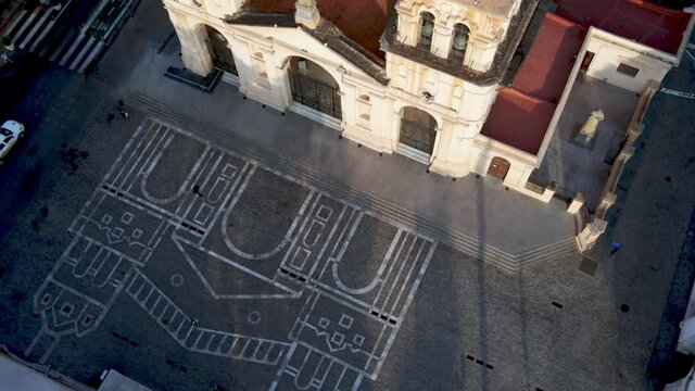 Aerial view of the Cathedral of Cordoba and painting on the ground in front of the church. Top down view