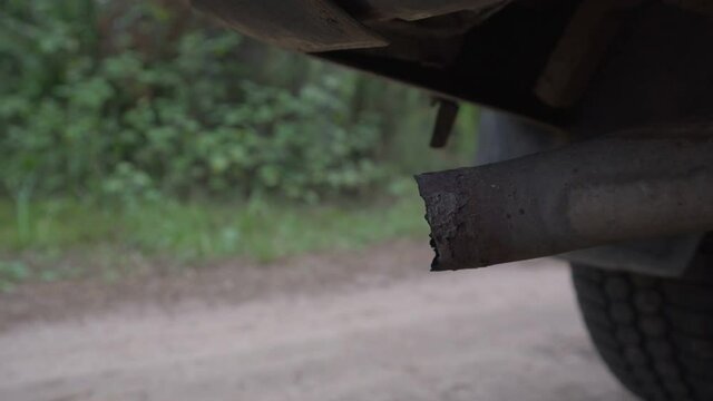 Vehicle rusty muffler with corrosion spots and pitting on edge. Transport care and service concept.