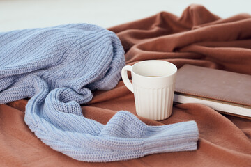 a blanket near the window a cup of coffee book Comfort rest