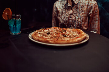 Close up photo of a business woman eating pizza on a lunch break. Selective focus