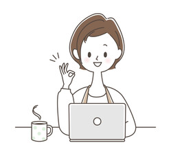 パソコンしながらOKサインを出す女性