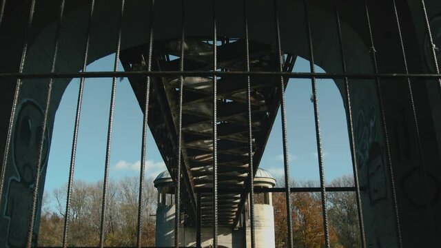 Old bridge structures of the historic weir on the Elbe. Bottom view through the protective grating. Camera dolly movement. Dramatic shot.