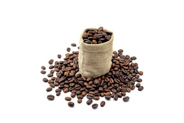 Heap of roasted coffee beans and hemp bag. isolated on a white background.