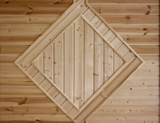 decorative element on the wall made of wooden slats in the form of a diamond close-up