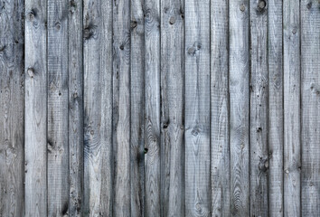wethered wooden fence with knots