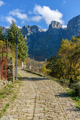 view of traditional architecture  with   stone buildings and background astraka mountain during  fall season in the picturesque village of papigo , zagori Greece