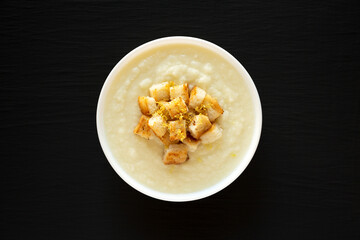 Homemade Cauliflower Soup with Croutons and Oil, top view. Flat lay, overhead, from above.