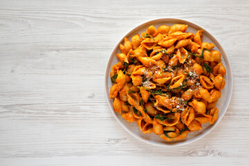 Homemade Pumpkin Pasta with Walnuts and Spinach, top view. Flat lay, overhead, from above. Copy space.