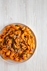 Homemade Pumpkin Pasta with Walnuts and Spinach, top view. Flat lay, overhead, from above. Copy space.