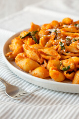 Homemade Pumpkin Pasta with Walnuts and Spinach, side view. Close-up.