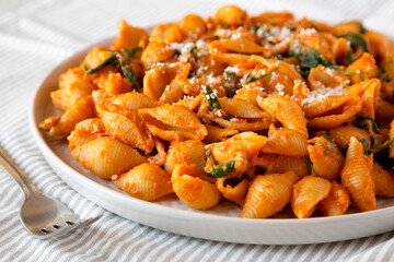 Homemade Pumpkin Pasta with Walnuts and Spinach, side view.