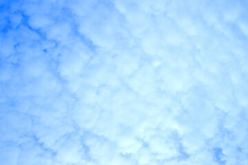 Blue sky with fluffy white clouds. Backgrounds