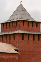 An old brick tower with a wooden roof. Close-up.