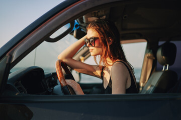 Fototapeta na wymiar woman driving in car trip posing fashion travel