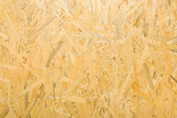 Yellow osb board for new wall, floor or other places. Closeup. Material for houses building. Empty place for text. Top down view.