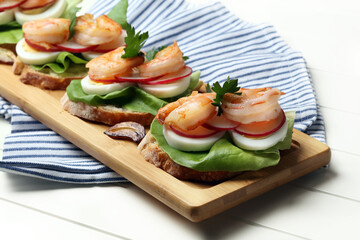 Homemade sandwiches with salad, eggs, radishes and shrimps