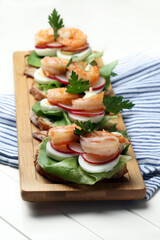 Homemade sandwiches with salad, eggs, radishes and shrimps