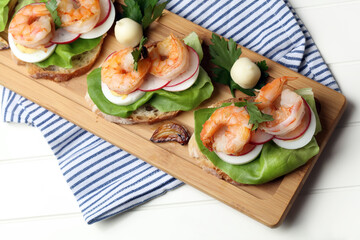 Homemade sandwiches with salad, eggs, radishes and shrimps