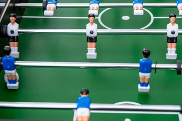 Table football in the entertainment center. Close-up image of plastic players in a football game.
