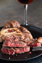 Ossobuco alla Milanese on dark plate with spices.