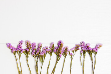 Purple flowers isolated on white wooden background