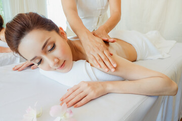 Young women relaxing in spa massage lie on your stomach on the bed