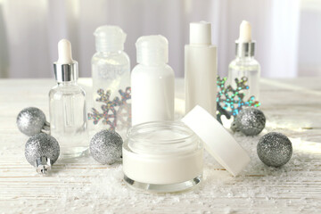 Fototapeta na wymiar Composition with winter cosmetic products on white wooden table