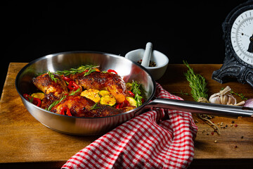 Fried chicken legs with various vegetables and spices